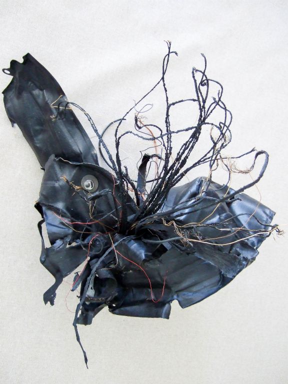 Out of Darkness Came Life, mixed media, recycled plastic, tire parts, bolts, paint, wires, 28"H x 20"W x 36" D